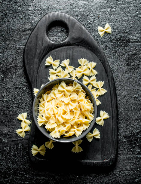 istock Farfalle pasta dry in a bowl on a cutting Board. 1144174188