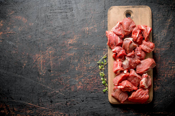 istock Cut raw beef on a wooden cutting Board. 1144177608