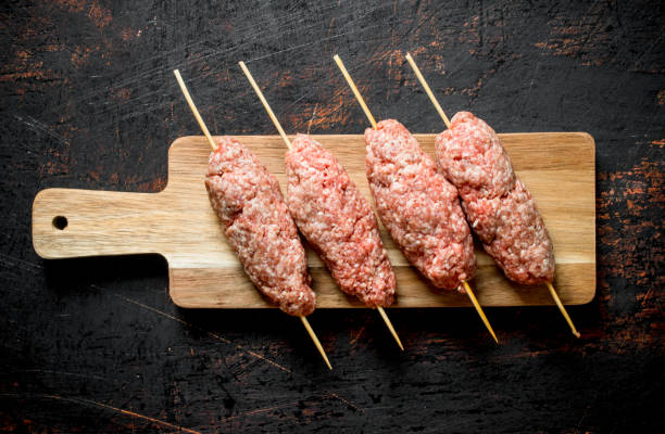 istock Raw kebab of ground beef on a cutting Board. 1144177634