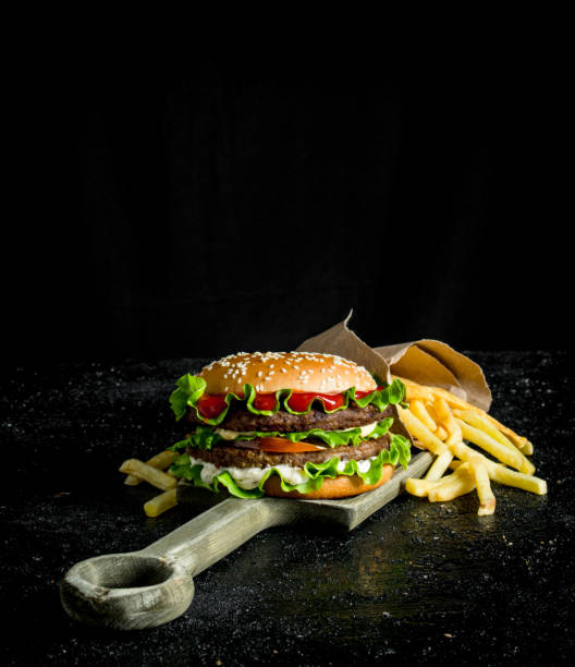 istock Burger with fries on the cutting Board. 1144178858