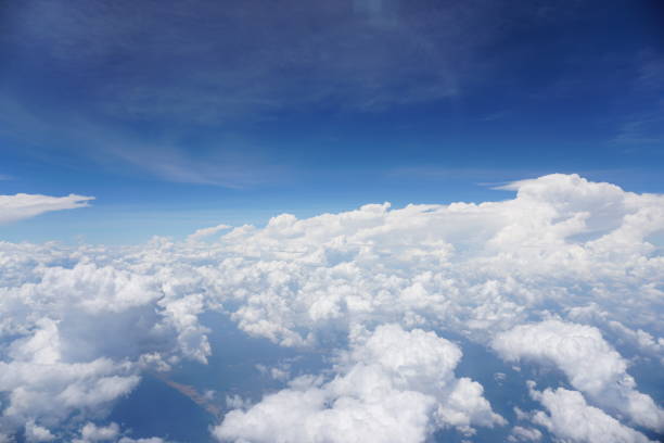 istock Clouds and sky as seen through window of an aircraft 1144178889