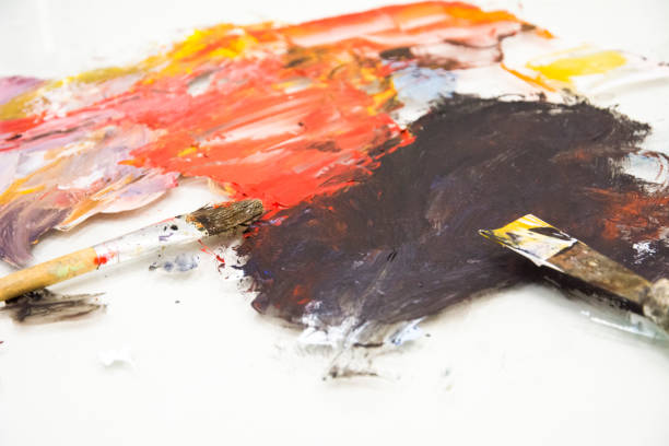 istock Artist paint brushes on wooden palette. 1144179247