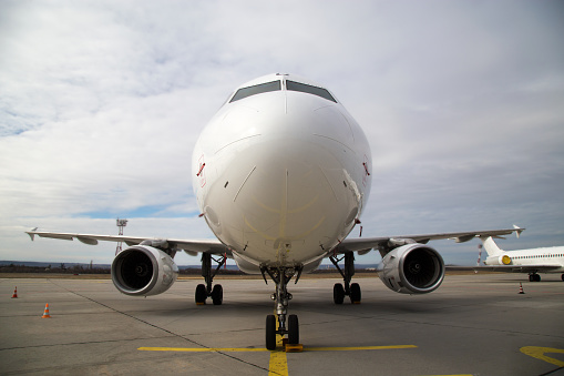 Front, bottom view of civil passenger airplane before departure at the airport\