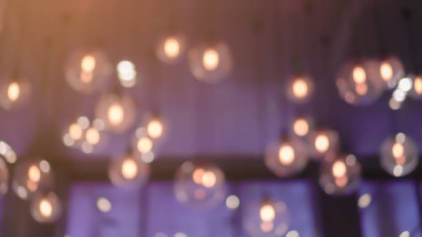 abstract blurred incandescent hanging on ceiling in luxury residence for loft and modern interior background concept