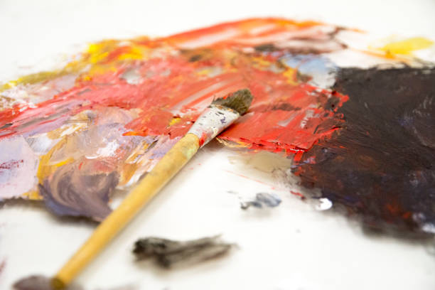 istock Artist paint brushes on wooden palette 1144183361