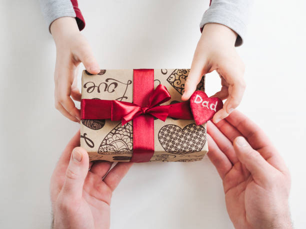 istock Child congratulating his Father. Preparing for the Fathers Day 1144185547