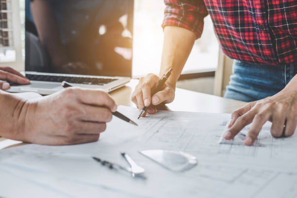 istock Construction and structure concept of Engineer or architect meeting for project working with partner and engineering tools on model building and blueprint in working site 1144186991