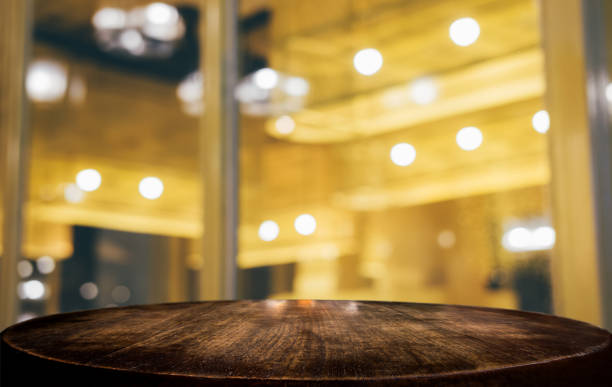 istock Selective Empty wooden table in front of abstract blurred festive light background with light spots and bokeh for product montage display of product 1144187010