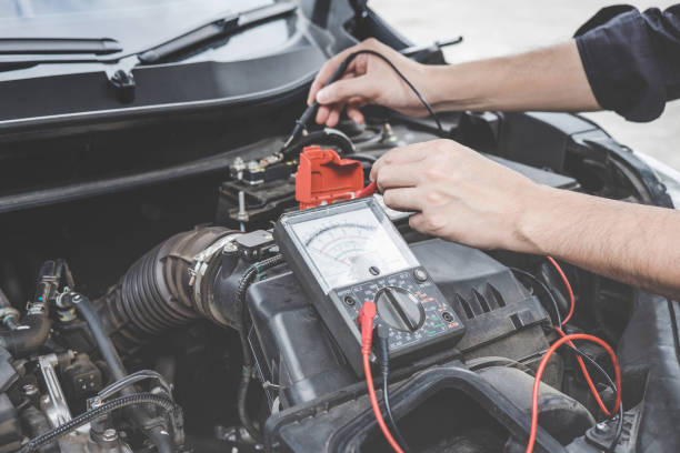 istock Services car engine machine concept, Automobile mechanic repairman hands checking a car engine automotive workshop with digital multimeter testing battery, car service and maintenance 1144187021