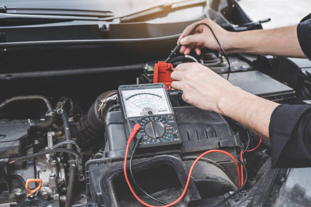 istock Services car engine machine concept, Automobile mechanic repairman hands checking a car engine automotive workshop with digital multimeter testing battery, car service and maintenance 1144187022