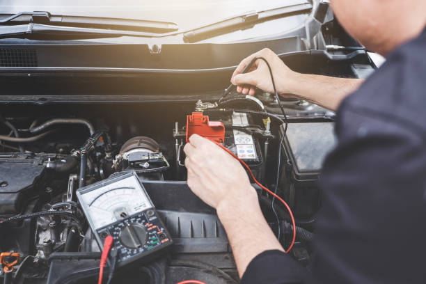 istock Services car engine machine concept, Automobile mechanic repairman hands checking a car engine automotive workshop with digital multimeter testing battery, car service and maintenance 1144187026