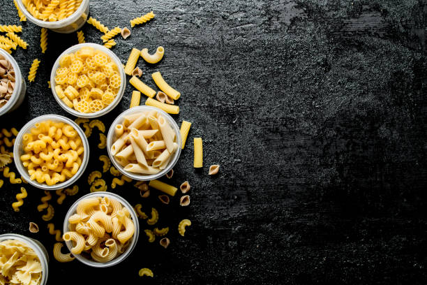 istock Different types of dry pasta in bowls. 1144188364