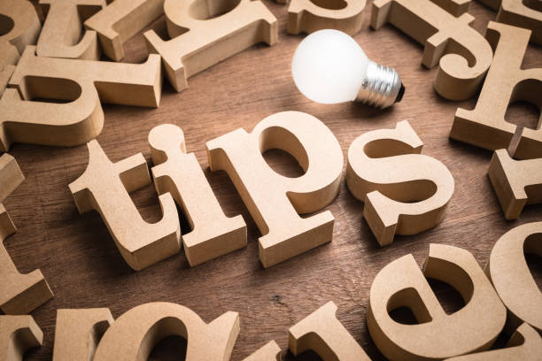 Tips Word and Idea Tips wood word in scattered wood letters with glowing light bulb study tips stock pictures, royalty-free photos & images