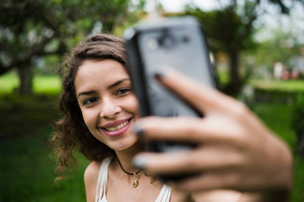 istock Beautiful young woman taking a selfie 1144189724