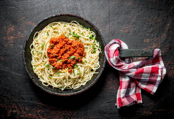 istock Spaghetti with Bolognese sauce in pan with napkin. 1144189844