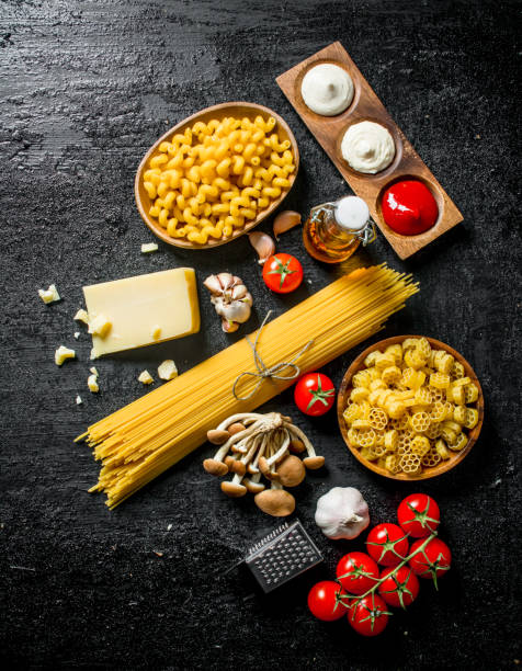 istock Different types of raw paste with Parmesan, mushrooms and tomatoes. 1144189846