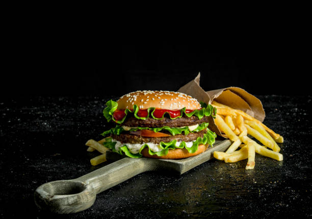 istock Burger with fries on the cutting Board. 1144190621