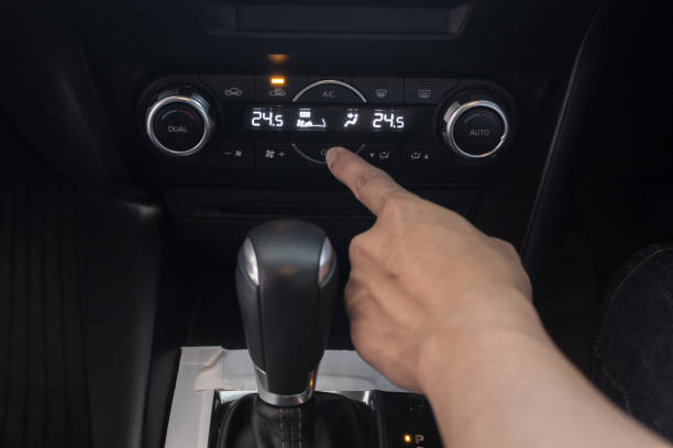 istock hand on air control buttons of a modern car. 1144190660