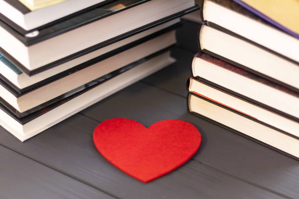 istock fabric heart with books on the table, reading love concept 1144190886