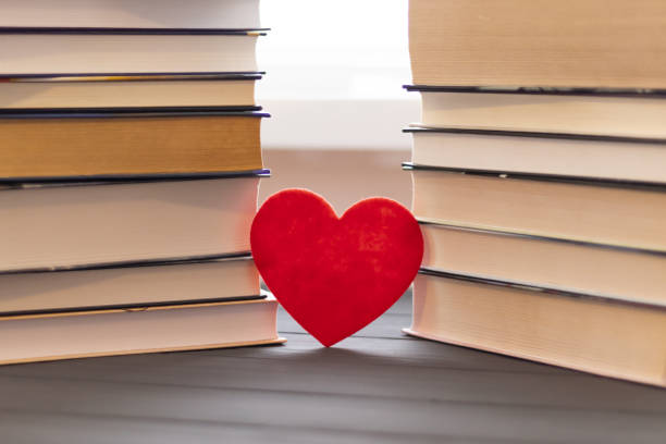 istock fabric heart with books on the table, reading love concept 1144190910
