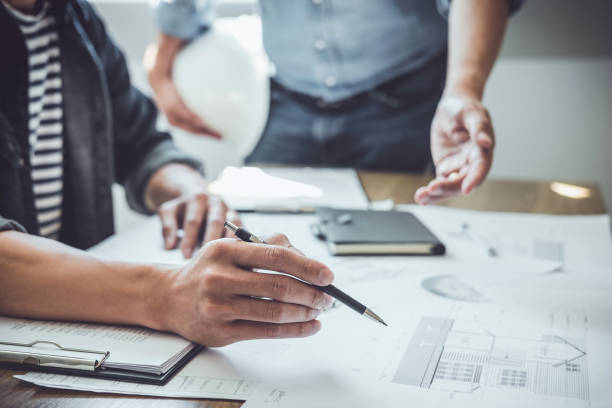 istock Construction and structure concept of Engineer or architect meeting for project working with partner and engineering tools on model building and blueprint in working site, contract for both companies 1144190955