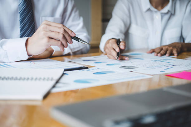 istock Co working conference, Business team colleagues discussing working analysis with financial data and marketing growth report graph in team, Meeting Talking Brainstorming Communication Concept 1144191122