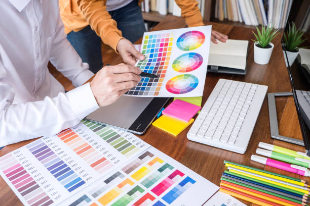 istock Team worker, Two colleague creative graphic designer working on color selection and color swatches, drawing on graphics tablet at workplace with work tools and accessories 1144191168