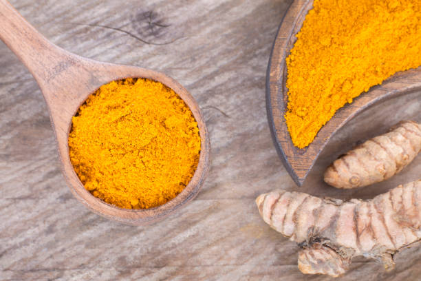 istock Turmeric powder and fresh turmeric - Curcuma longa. 1144191246