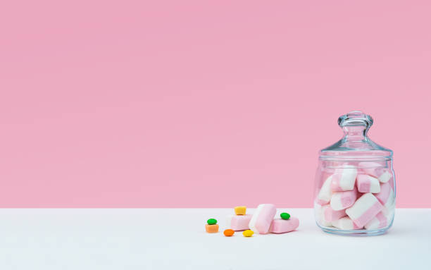istock Marshmallow with dragee next to the glass transparent jar and in it 1144192556