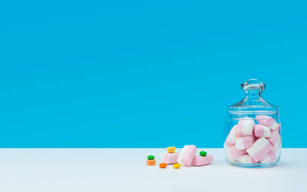 istock Marshmallow with dragee next to the glass transparent jar and in it 1144192596