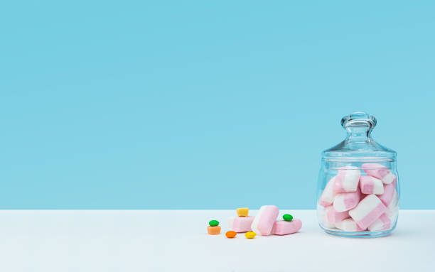 istock Marshmallow with dragee next to the glass transparent jar and in it 1144192598