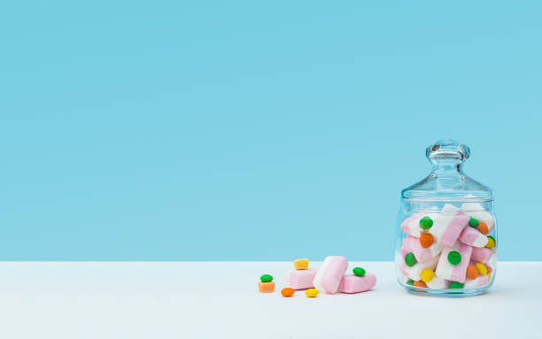 istock Marshmallow with dragee next to the glass transparent jar and in it 1144192641