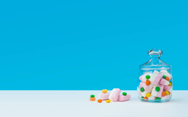istock Marshmallow with dragee next to the glass transparent jar and in it 1144192696