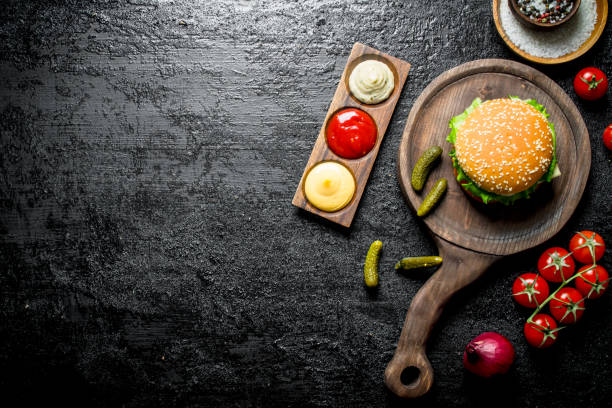 istock Burger with sauces,tomatoes and spices. 1144192818