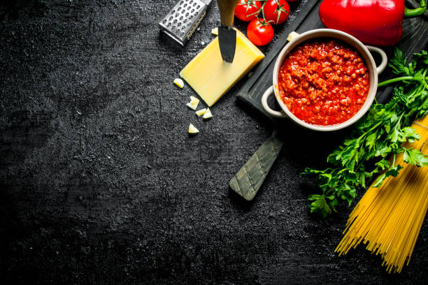 istock Bolognese sauce in a pan with dry pasta and cheese. 1144193816