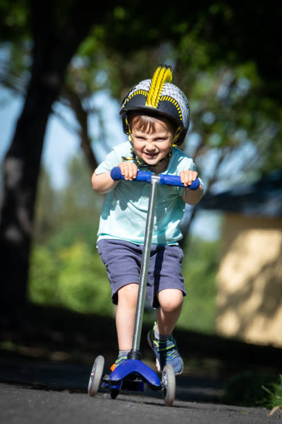 istock Three years old child boy riding his push scooter 1144193913