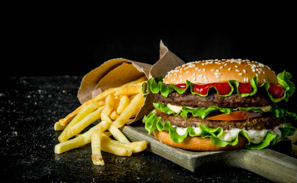 istock Burger with fries on the cutting Board. 1144194037