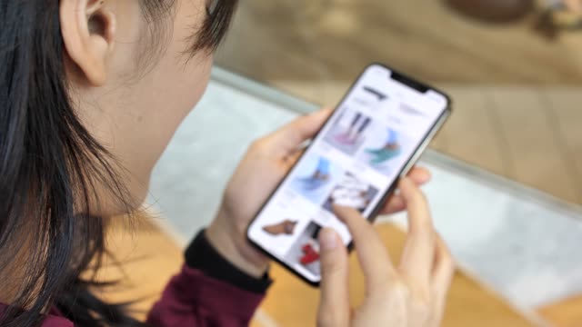 Woman looking at the goods in the online clothing store, Smart phone online shopping, Slow motion.