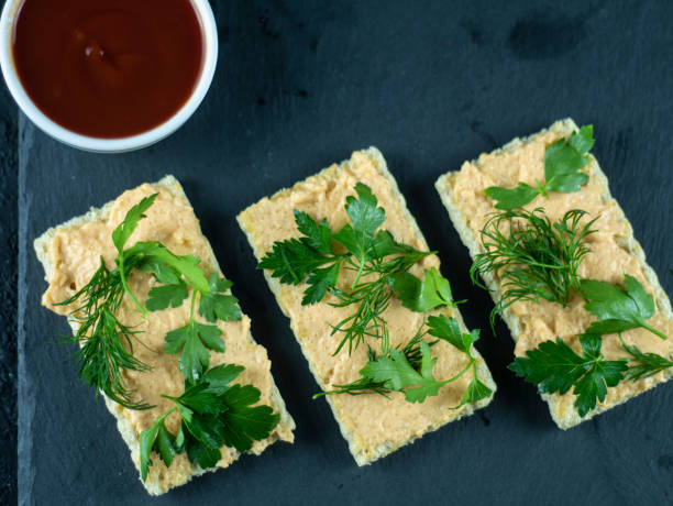 Healthy breakfast with crispbread and cream cheese and souse on dark stone background