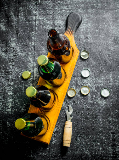istock Beer bottles on a stand and opener. 1144196265