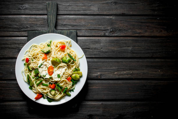istock Pasta with Brussels sprouts,broccoli and tomatoes. 1144196465