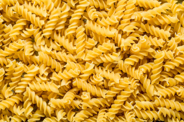 istock Pasta background. Dry pasta fusilli. 1144196558