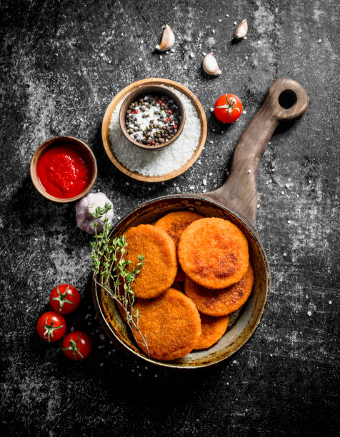 istock Fish cutlets with spices,thyme, garlic and sauce in bowl. 1144198164