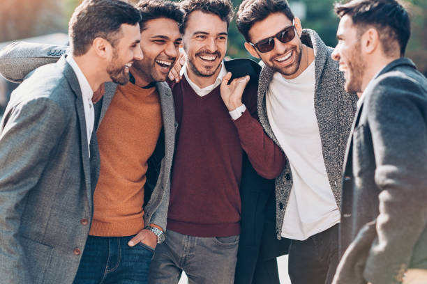 istock Group of young businessmen talking and laughing 1144198348
