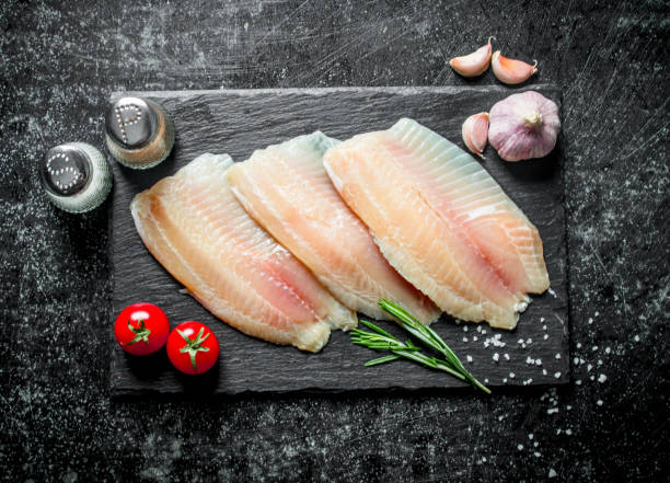 istock Fish fillet with garlic,spices and tomatoes. 1144198491