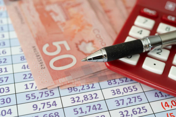 istock Canadian Dollar Notes on spreadsheet with Calculator 1144198579