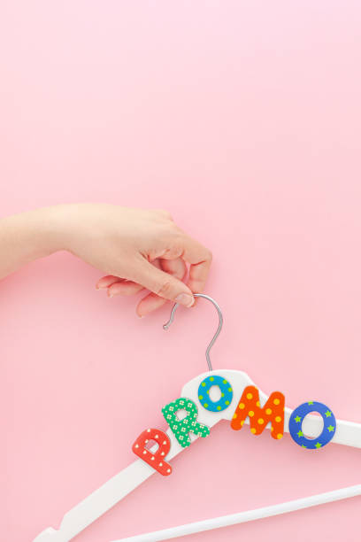 istock White hangers with promo text on pink background 1144199215