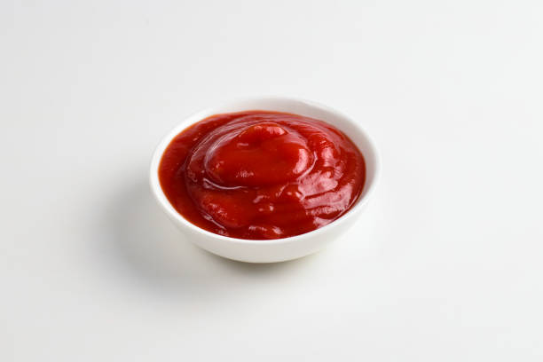 istock Ketchup in white plate on white background. 1144199640