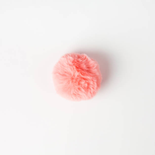 istock Coral fluffy fur ball on white background 1144200014