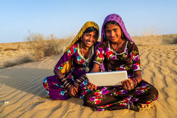 istock Happy Gypsy Indian girls using digital tablet, India 1144200114